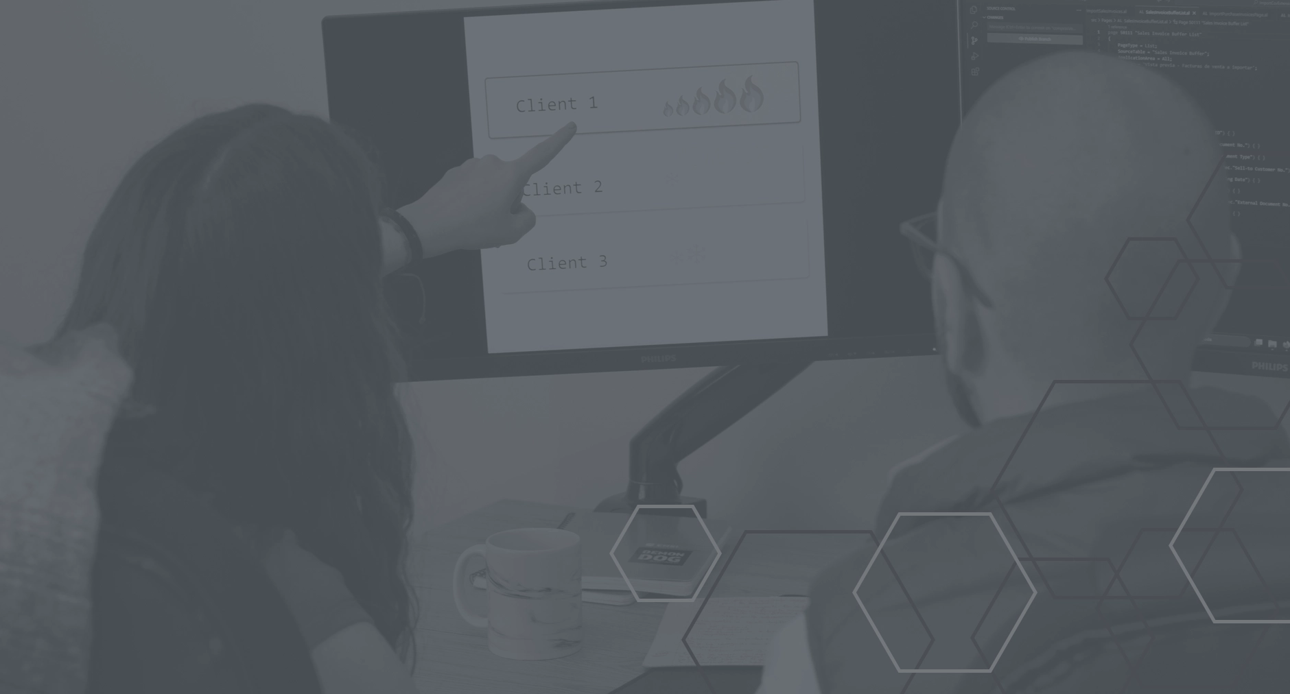 Two people analyzing client performance on a computer screen