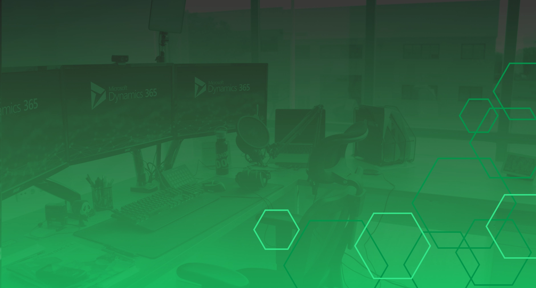 Modern workstation with dual monitors displaying Dynamics 365