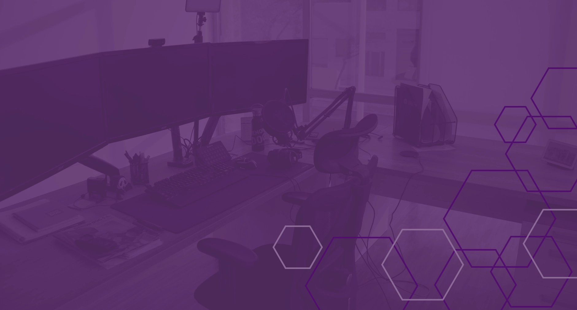 Modern dual-monitor workstation with purple overlay and hexagonal design